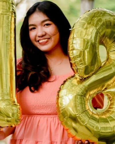 girl with 18th birthday balloons.