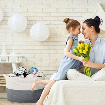 This mother and daughter are happy that their bedroom is organized using a basket to contain items off the floor. 