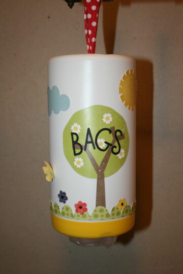 A baby wipe container can be decorated and used to store other items, like this cute container for bags. 