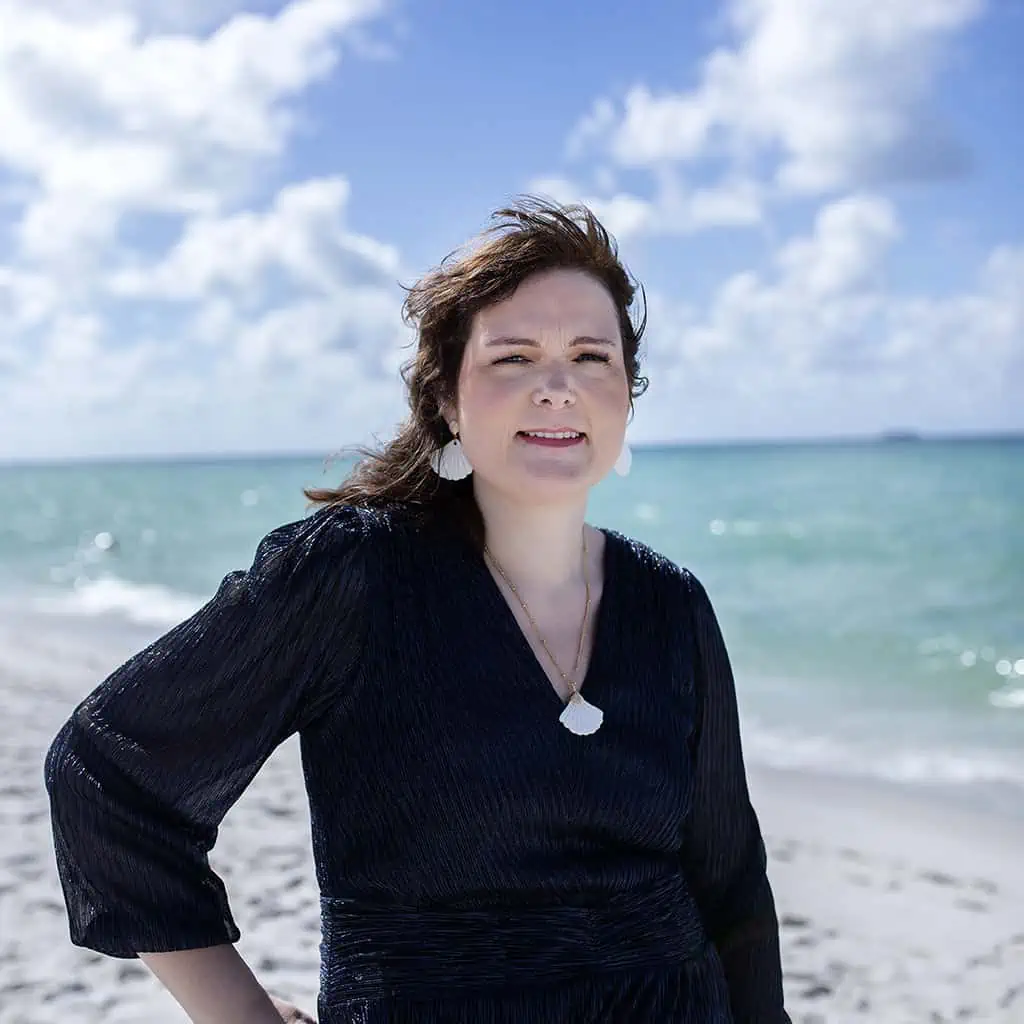 This is a photo of Becky Beach smiling at the beach.
