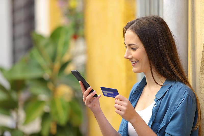 Woman using her card online to cash a check.