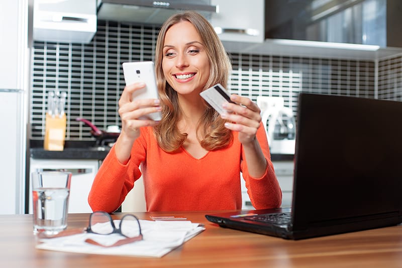 Woman using credit card for check cashing.