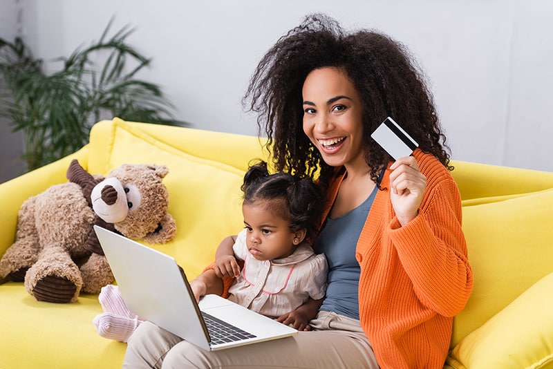 Mom with a credit card shopping online.