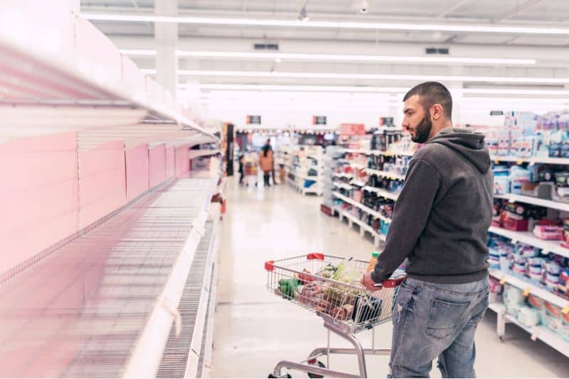 Man pushing shopping cart