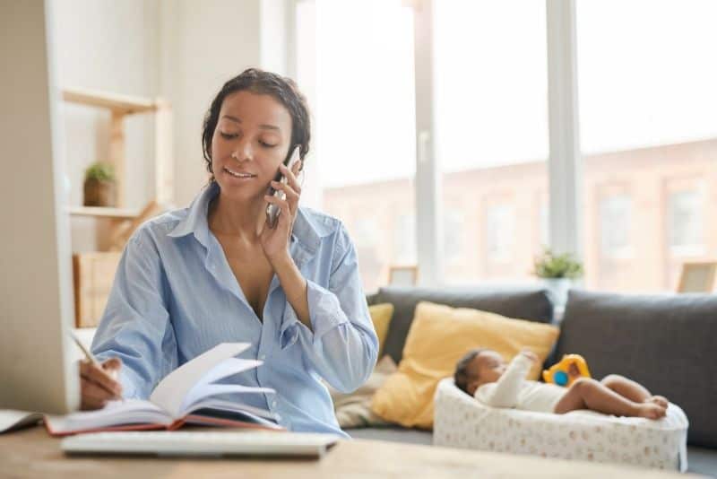 Woman with child doing at-home transcription.
