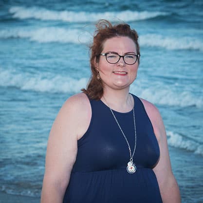 This is a photo of Becky Beach smiling at the beach.