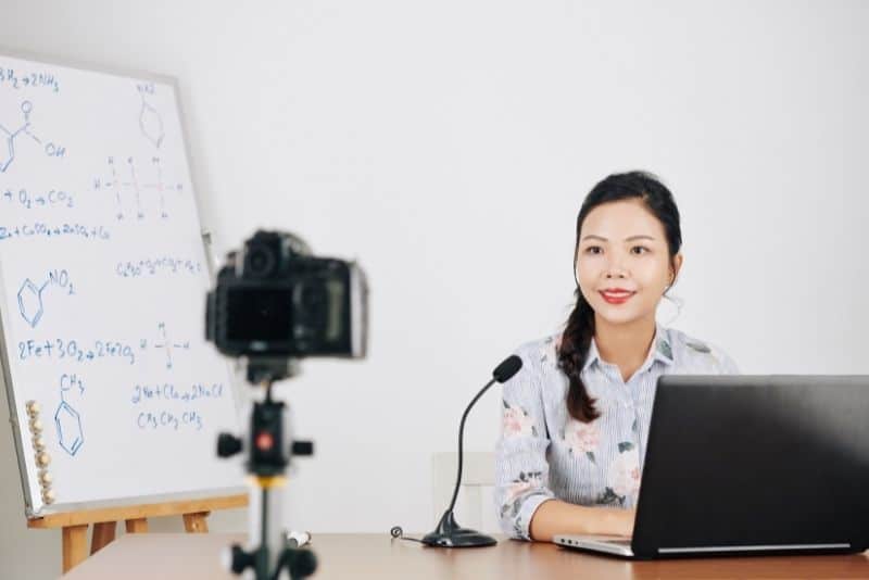 Woman teaching math on online course platform.