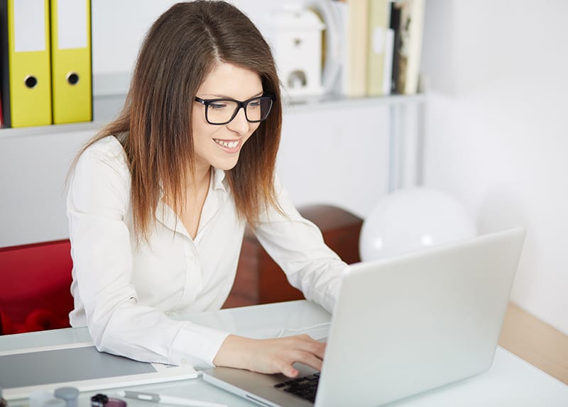 Happy woman working on her computer.