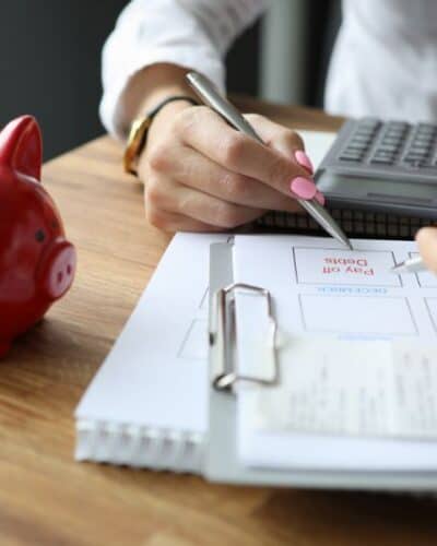 Woman paying her debt off with the bi-weekly savings plan.