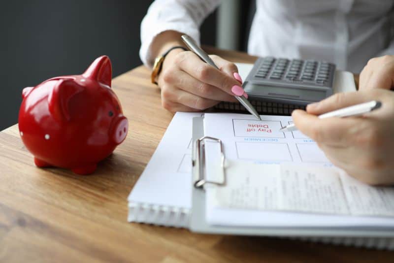 Woman paying her debt off with the bi-weekly savings plan.