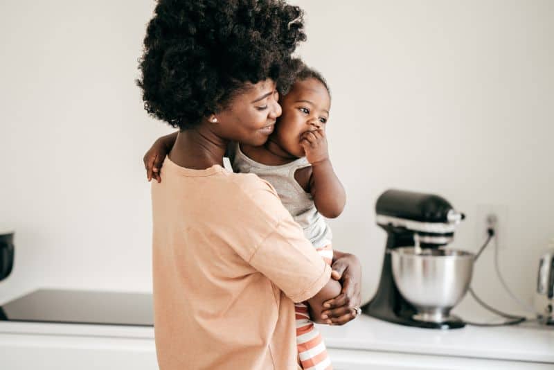 Woman with her child after paying off debt.