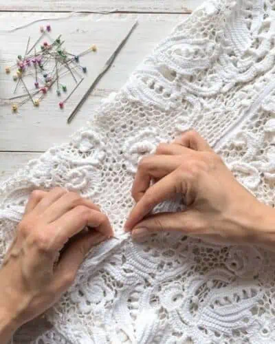 bride sewing zipper in her wedding dress