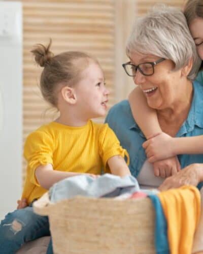 Kids doing laundry with grandma.