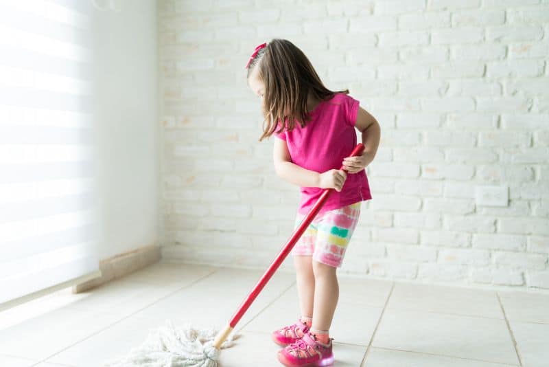Kid mopping the floor.