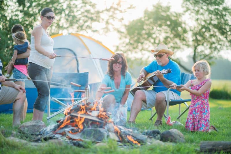 Family cooking at campsite.