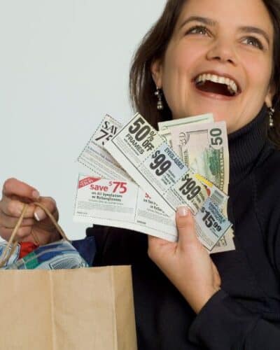 Woman saving money with coupons.