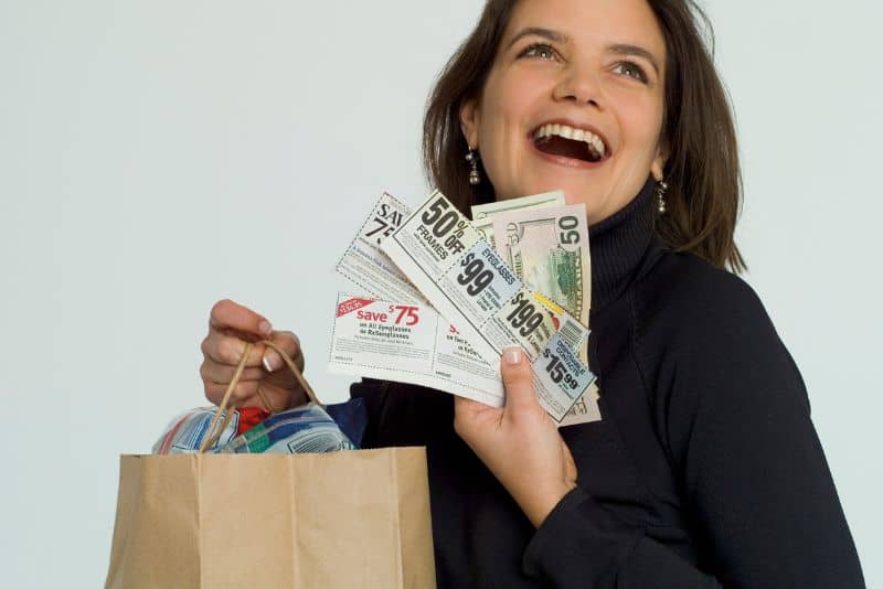 Woman saving money with coupons.