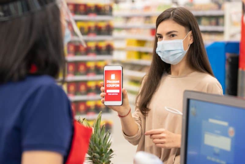 Woman couponing at grocery store.