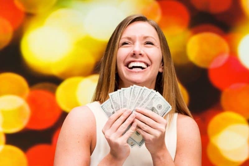 Woman with money from selling on Decluttr - Decluttr Review