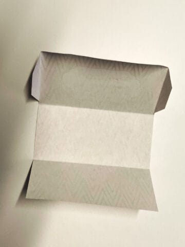 To fold a cash envelope template, score on the dotted lines.
