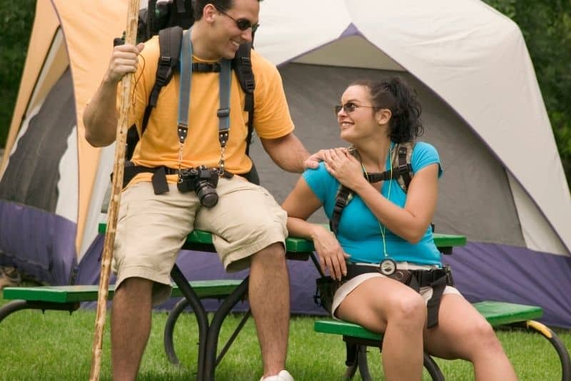 Couple going on a camping trip together on a free date idea.