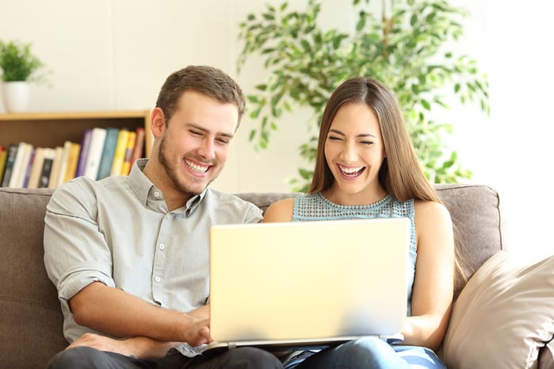 Like this happy couple, you can watch videos on your laptop and earn free money!