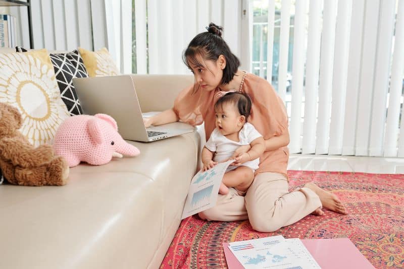 Woman with child going over her credit.