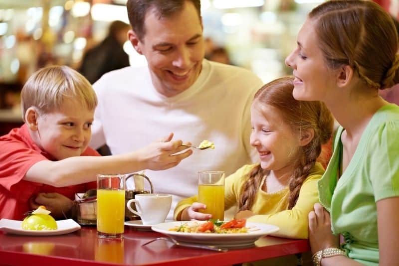 Family saving money while eating out together.