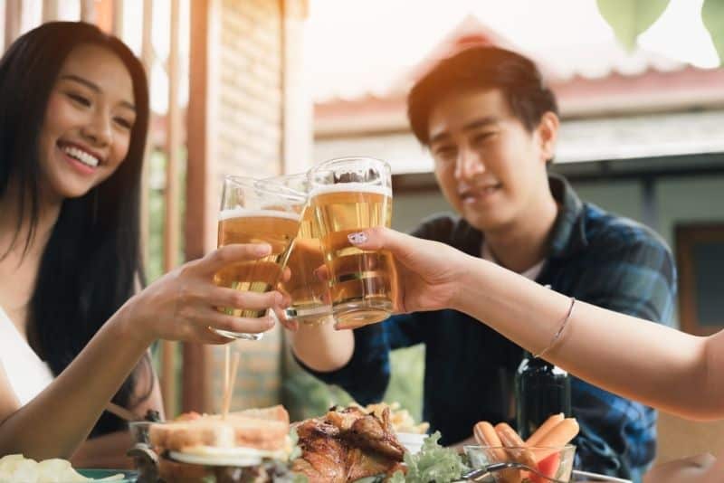 Friends eating out during happy hour so that they save money dining out.
