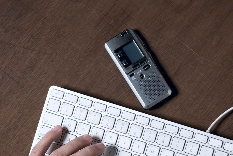 Woman transcribing what she is hearing on a device.