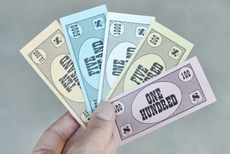 man's hand holding play money