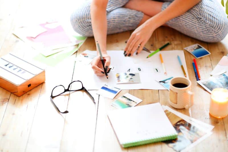 Woman making a money vision board.