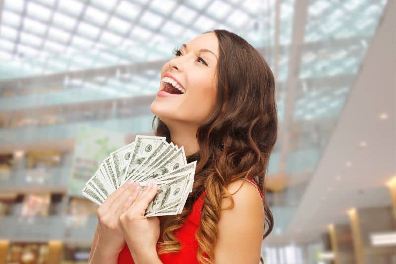 Woman with money and being happy.
