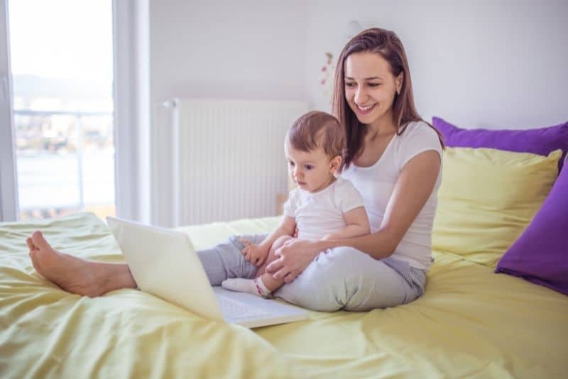 Mom taking courses online with child to learn proofreading.