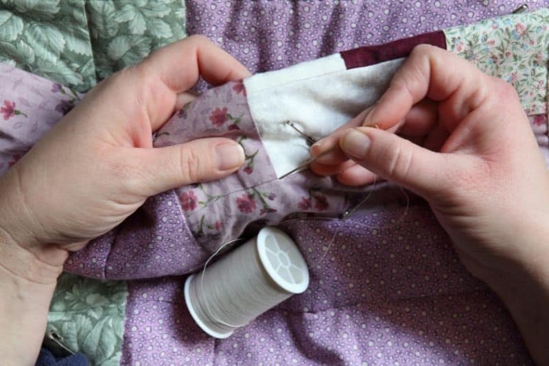 Woman sewing quilts to make money online.