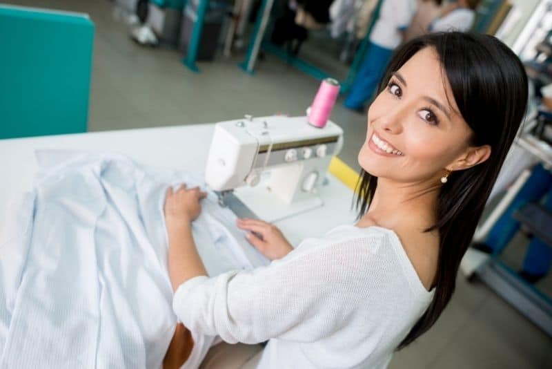 Woman sewing clothes to make money online.