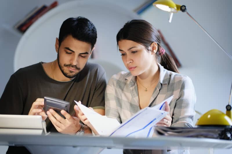 Couples like this man and woman should sit down together to review finances and calculate monthly expenses. 