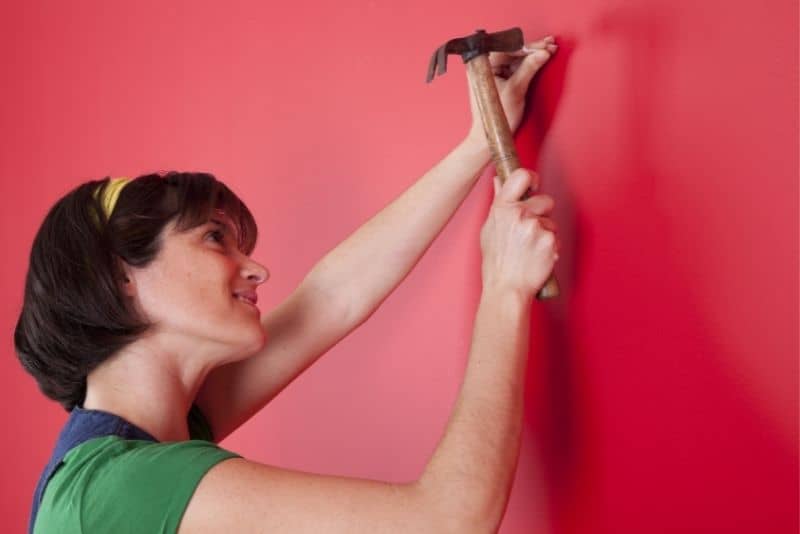 Mom fixing a wall and doing an odd job.