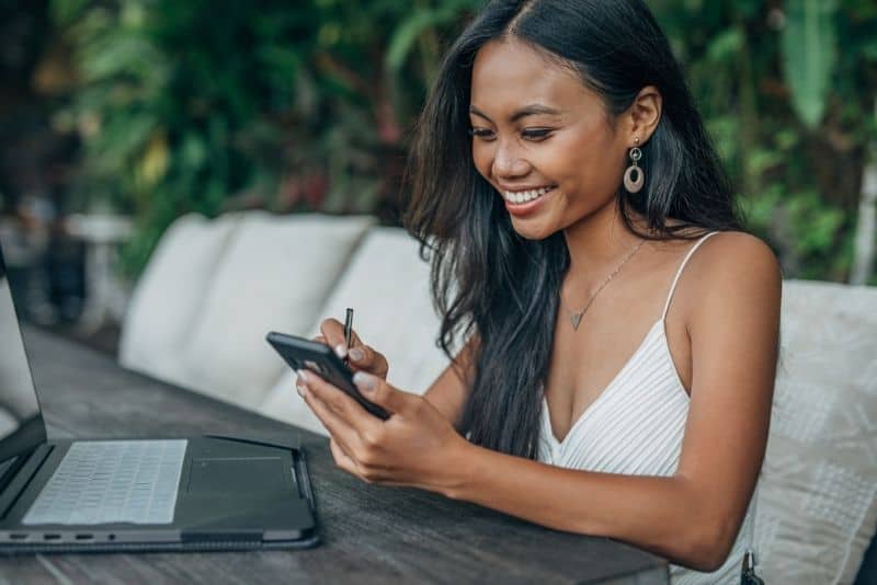 Woman blogging from home as a side hustle business idea.