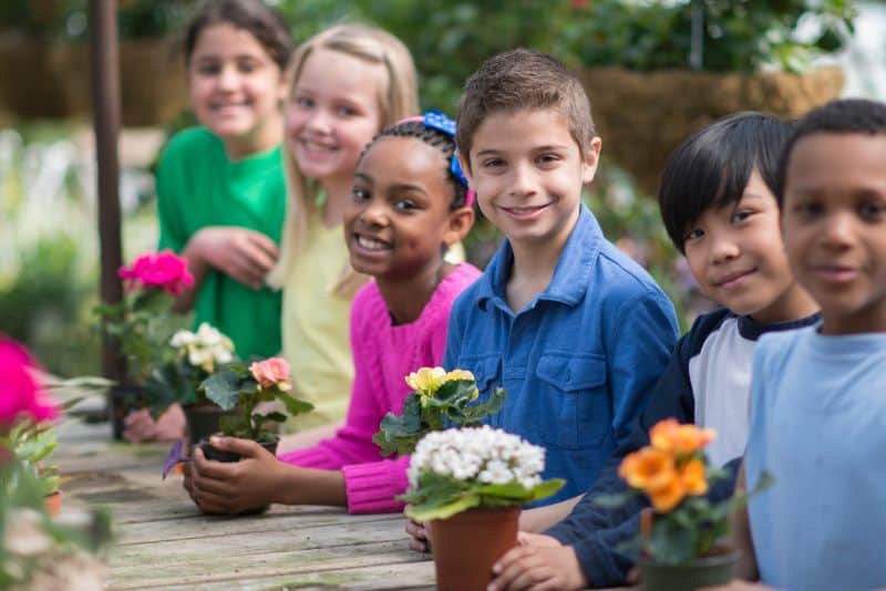 Kids gardening outside.