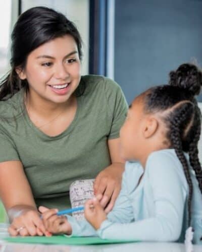 Woman teaching kid as a summer job for teachers.