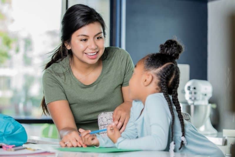 Woman teaching kid as a summer job for teachers.